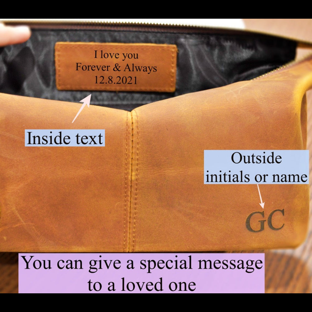 Brown leather bag with personalized text and initials on a wooden surface