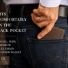 A close-up lifestyle shot of a man's hand sliding a brown leather wallet into the back pocket of his blue jeans. The wallet has 'CIT' embossed on the corner.