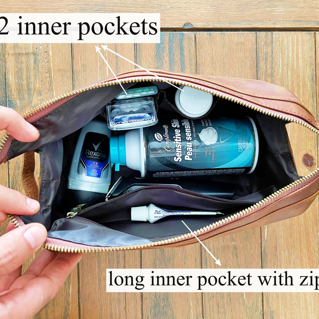 Open brown leather bag with two inner pockets and a long inner pocket with zipper, containing toiletries.