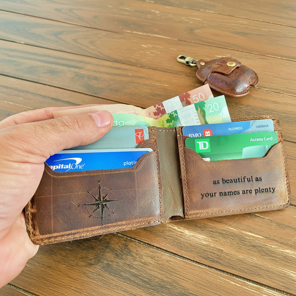 Brown leather wallet with various cards and cash on a wooden surface