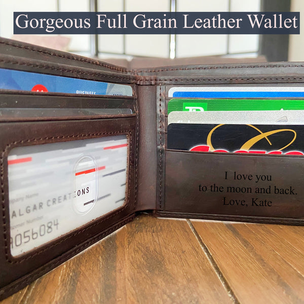 Brown leather wallet with card slots and engraving on a wooden surface